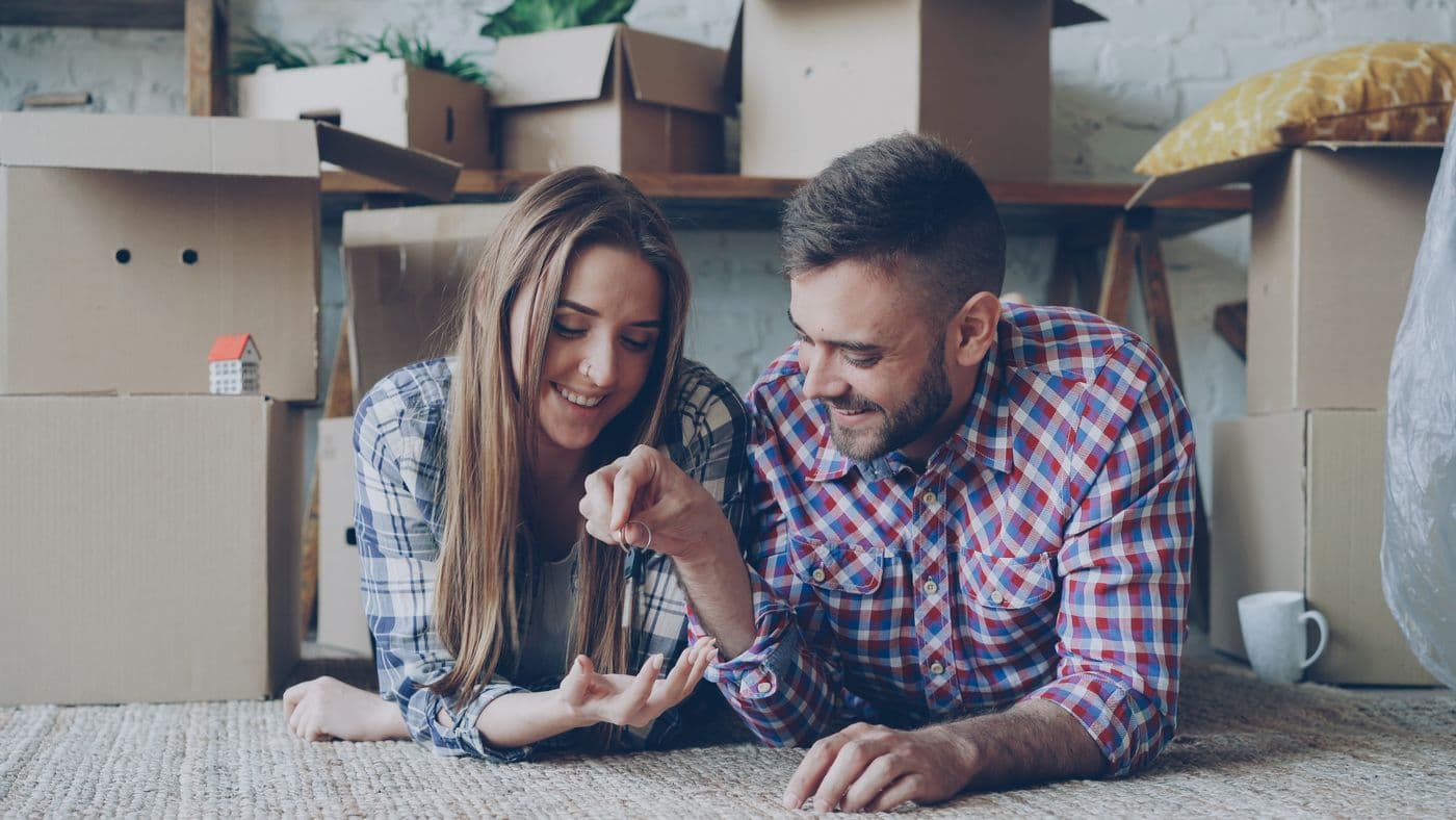 Couple with moving boxes, beginning their next chapter